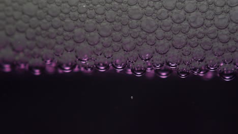 closeup of soap bubbles on purple liquid