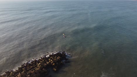 Two-kayaks-near-breackwater-in-Atlantic-Ocean,-Mar-del-Plata