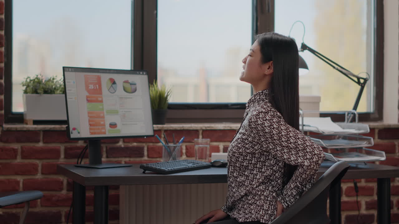 Entrepreneur suffering from back pain at office desk