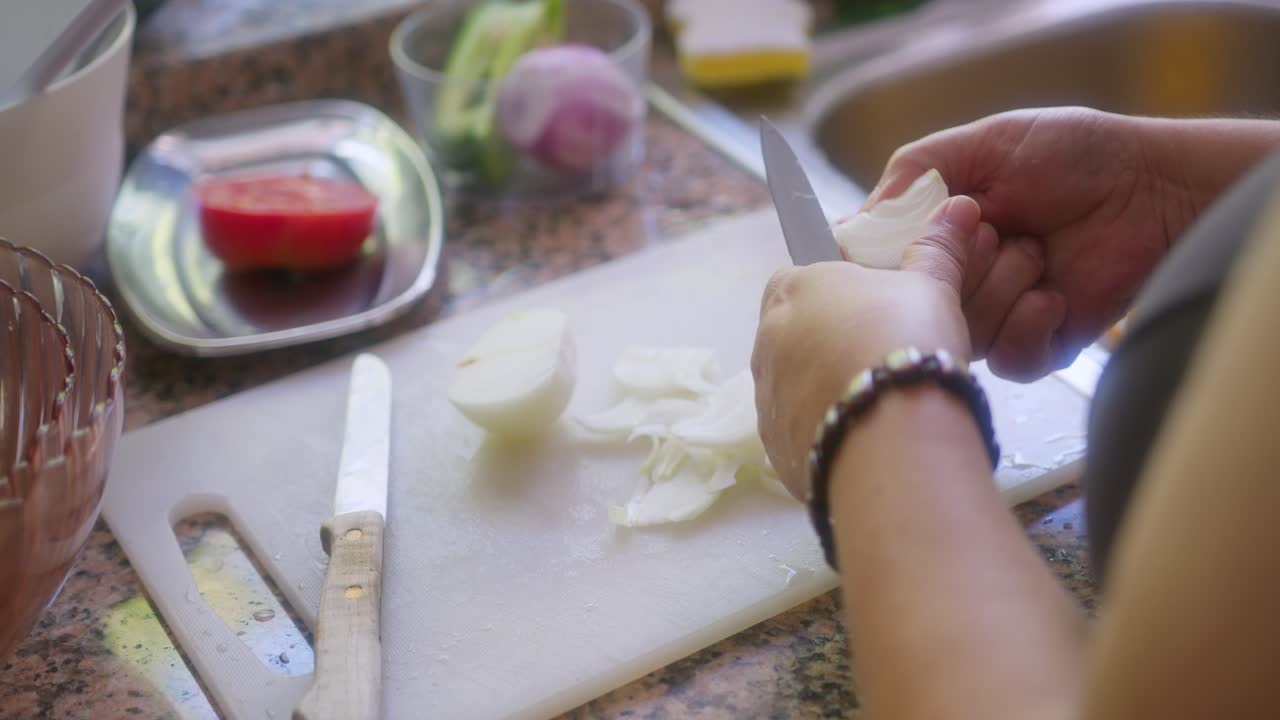 Close Up of a Woman Chopping Onions