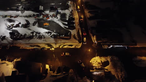 trucks waiting at the intersection on a snowy night