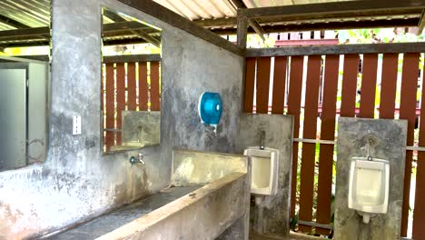 empty male restroom with sinks and urinals