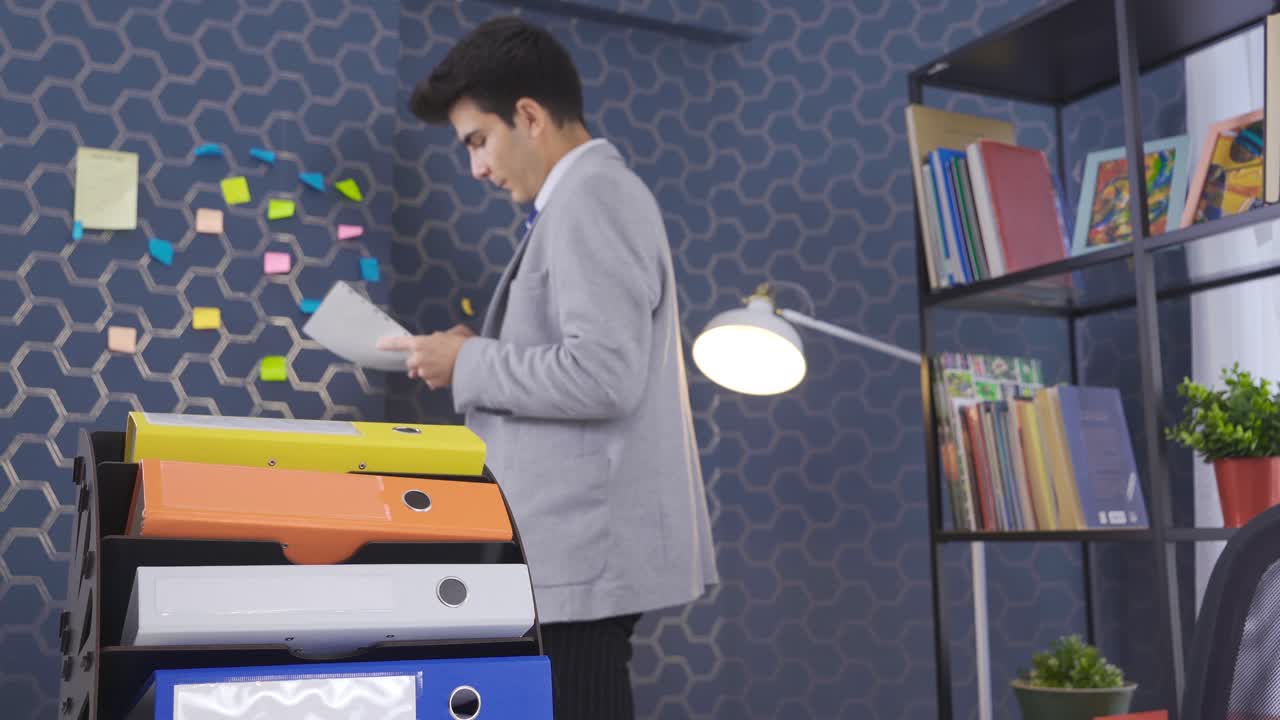 Businessman working in office and taking notes.