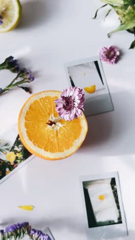 orange slice with flowers and instant photos