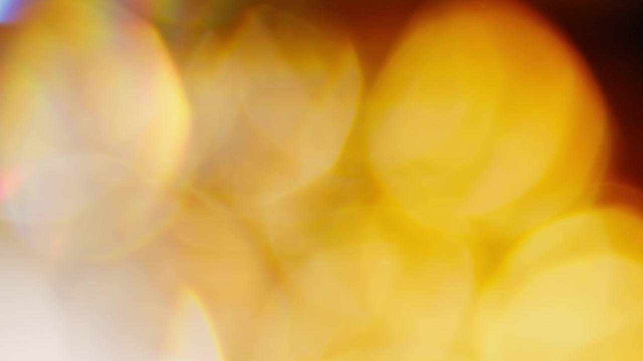 Abstract particles of light move against a black background