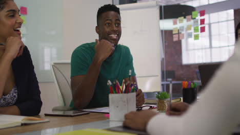 Mixed-race-business-colleagues-sitting-having-a-discussion-in-meeting-room