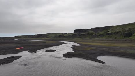 Aerial-View-of-Icebergs-in-Glacial-Lake-and-River-Outflow-in-Landscape-of-Iceland,-Drone-Shot-60fps