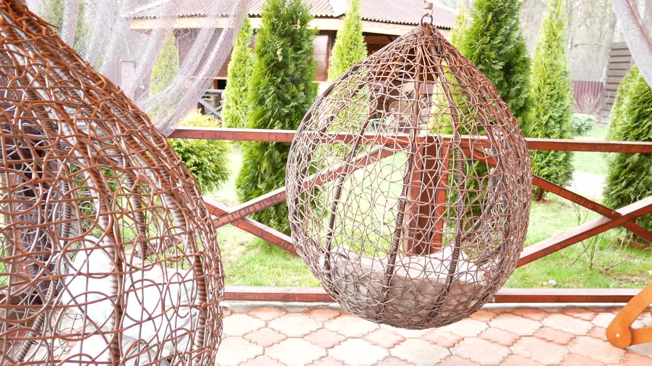 Swing a cocoon in the yard. Hammock for relaxation and rest 4k video.