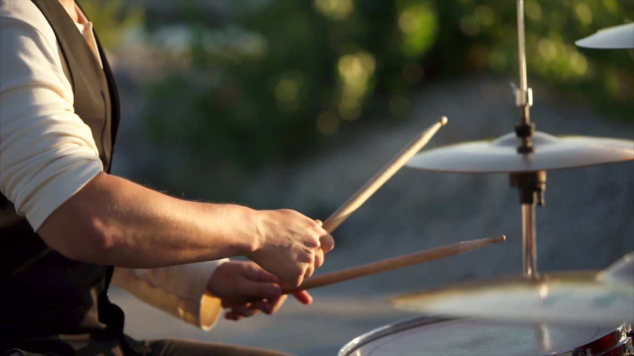 Drummer playing drums outdoors