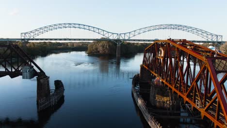 intense dronefootage of drone flying in between an old rotating railway bridge in middletown, connecticut, arrigoni bridge in the background