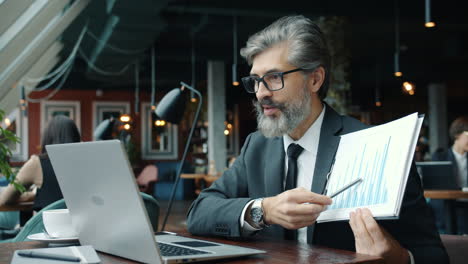 businessman presenting data in coffee shop