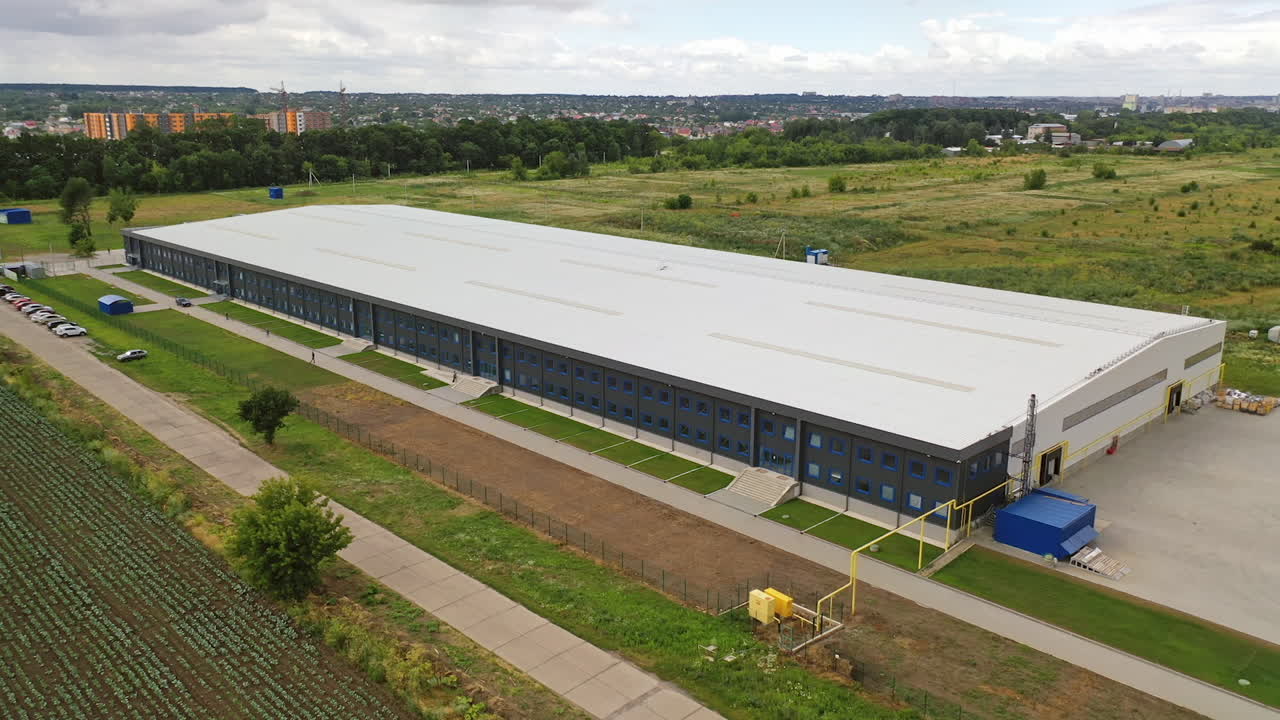 Contemporary industrial factory. Exterior of a large modern production plant in the countryside. Modern production company outdoors. Aerial view.