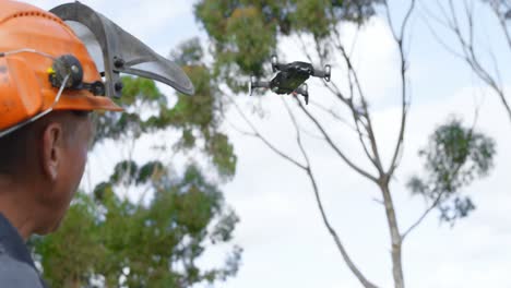 lumberjack operating drone in forest 4k