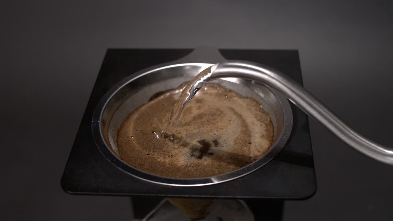 Pouring hot water into a coffee maker in super slow motion