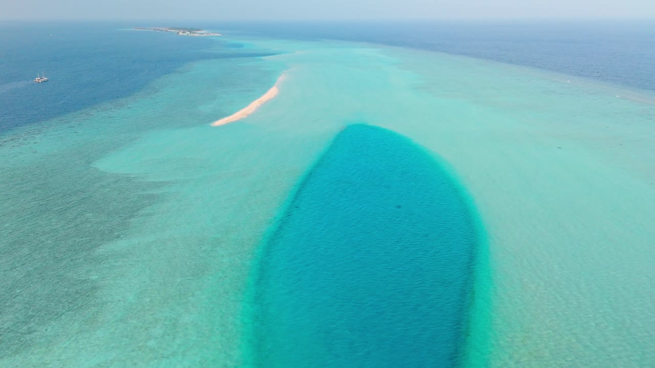 A stunning aerial drone view captures the pristine Rasdhoo Sandbanks surrounded by crystal-clear turquoise waters in the Maldives.
