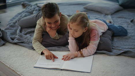 Smart-siblings-reading-book-at-home.-Brother-and-sister-gaining-new-knowledge.