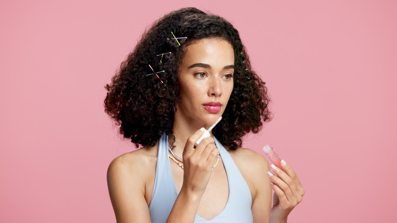 Woman applying lip gloss