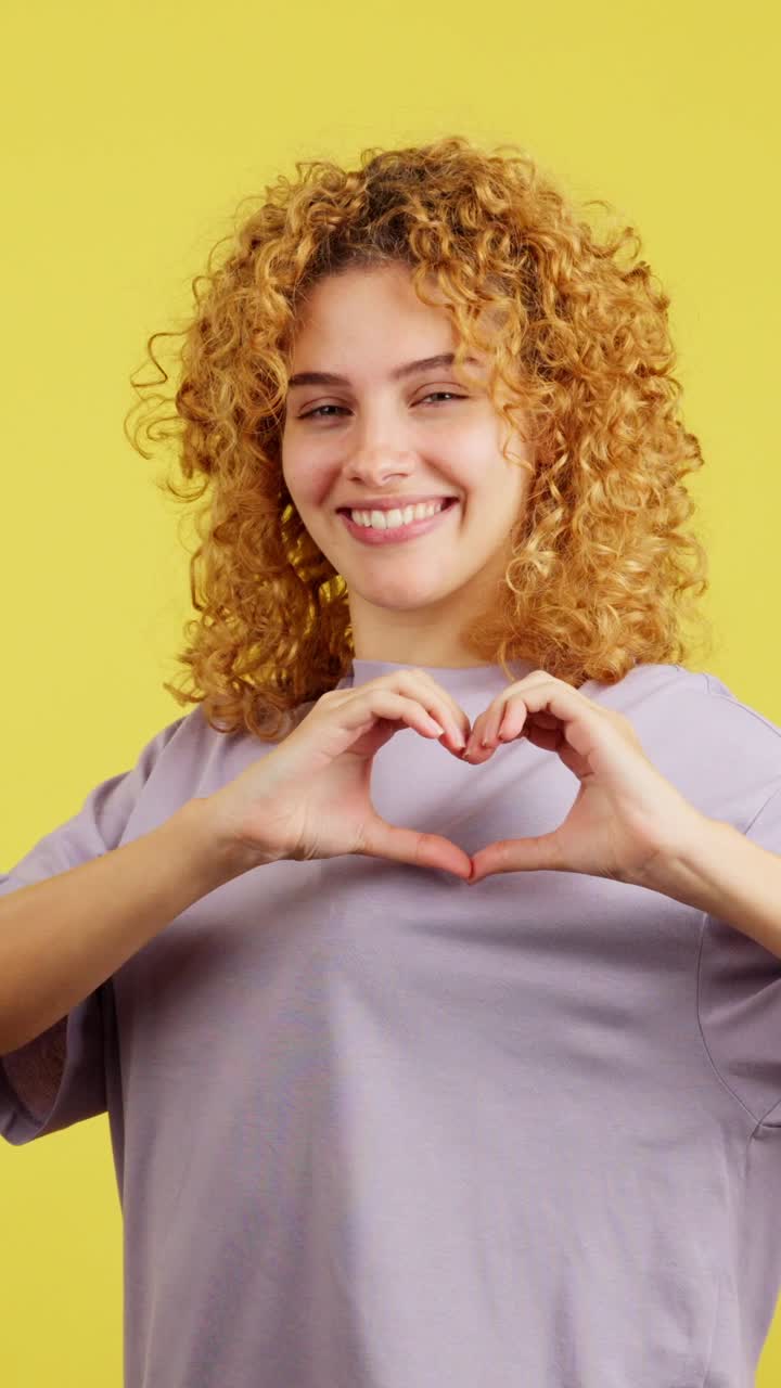 Young Woman Making a Heart Shape with Her Hands