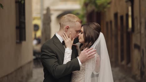 Newlyweds,-caucasian-groom-with-bride-walking,-embracing,-hugs-in-city,-wedding-couple-in-love