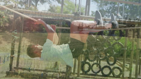 in school, child climbing rope on playground with trees and equipment around