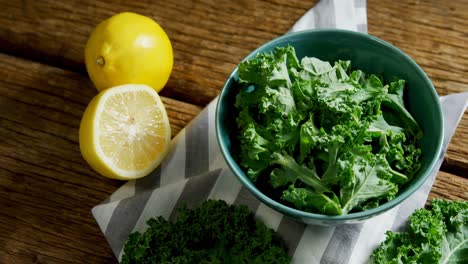 green leafy vegetable in a bowl on wooden table 4k