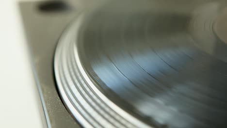 Close-up-of-retro-spinning-vinyl-record---Old-LP-player-concept