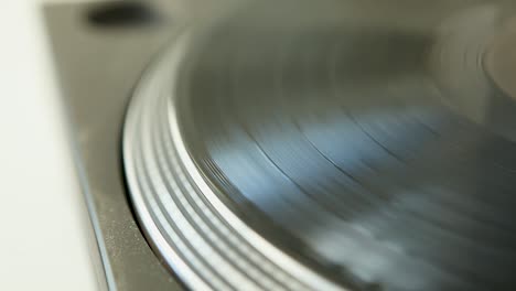 close up of retro spinning vinyl record - old lp player concept