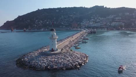 aerial view of lighthouse and harbor in a coastal city