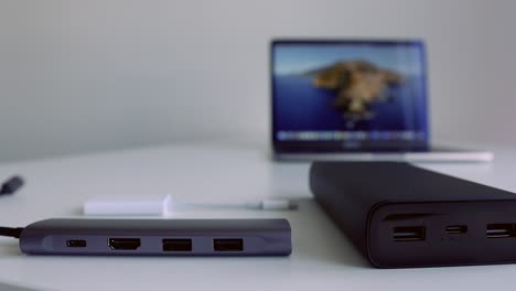 laptop with power bank and accessories on a desk