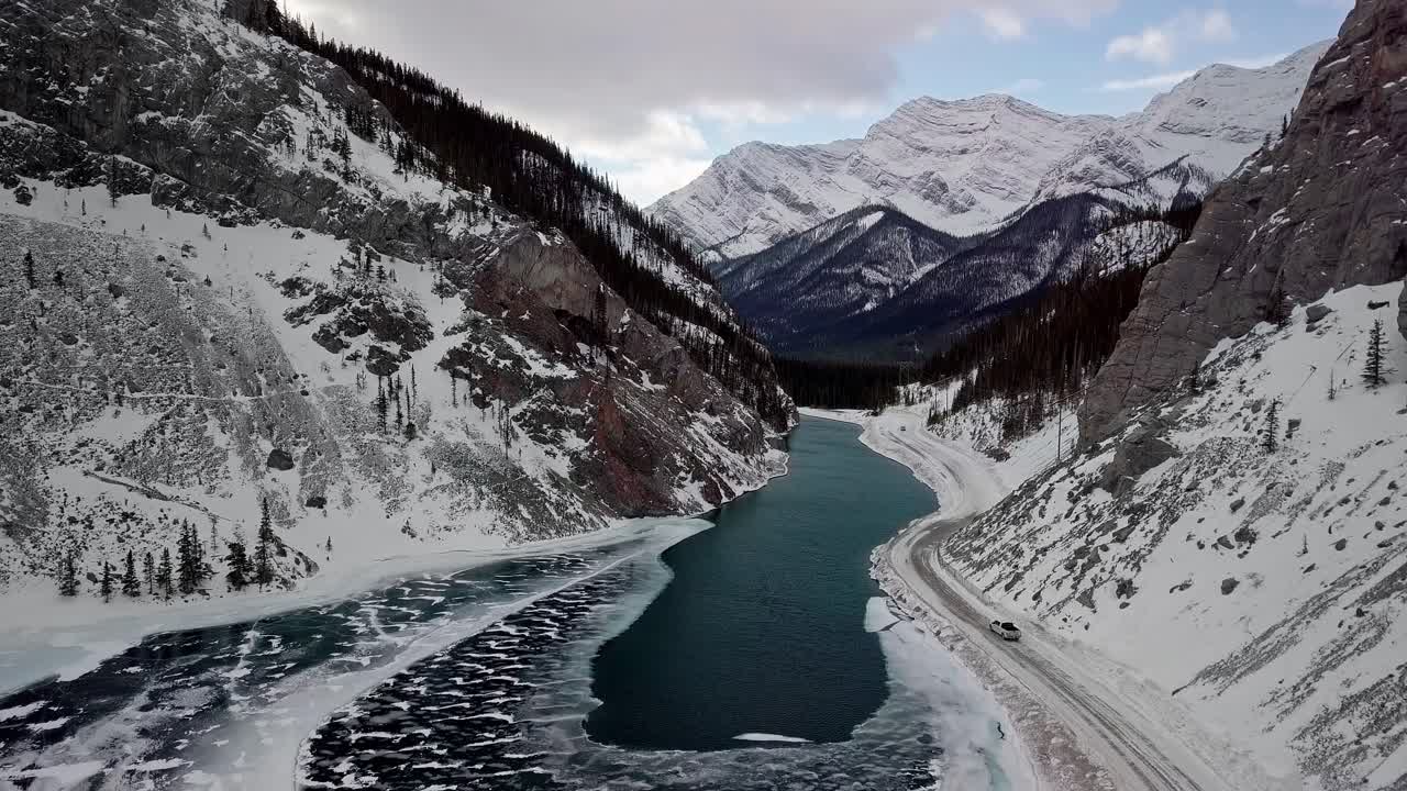 A road pass by the beautiful Bow River in the Spray Lakes Reservoir in Canada - aerial