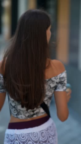 woman walking on the street with a reusable coffee cup