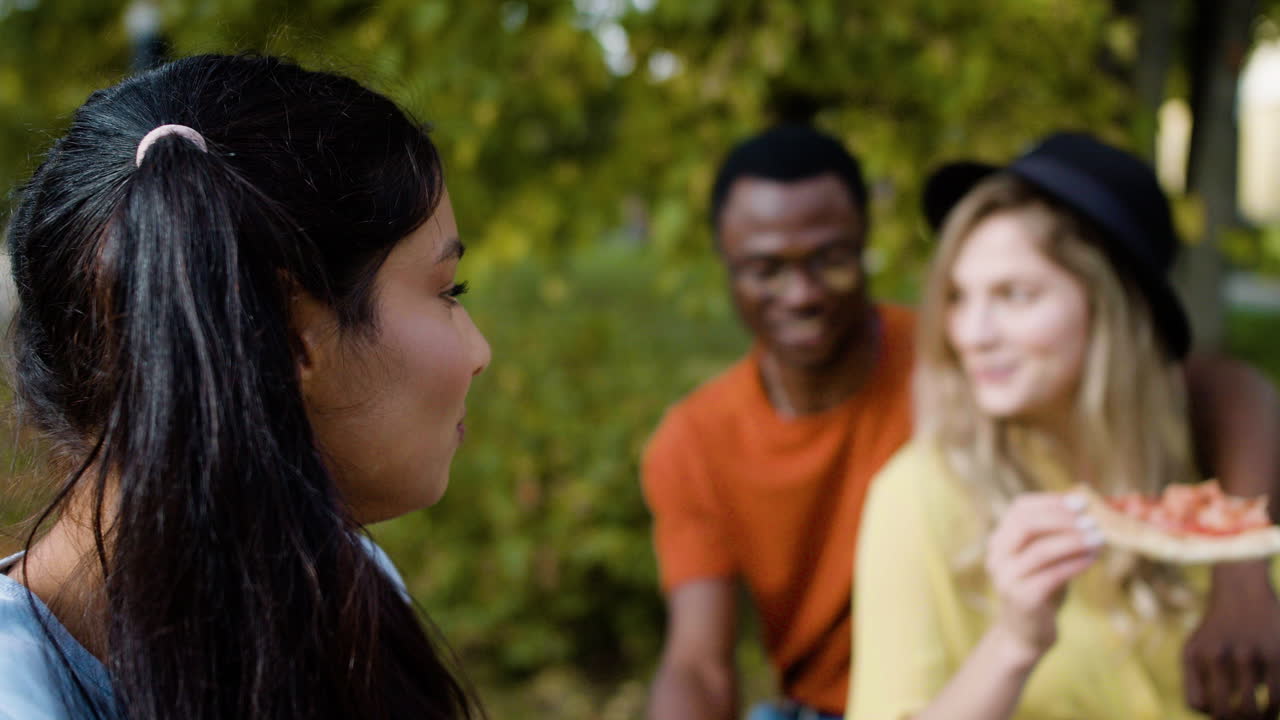 Close-up of woman eating with her friends