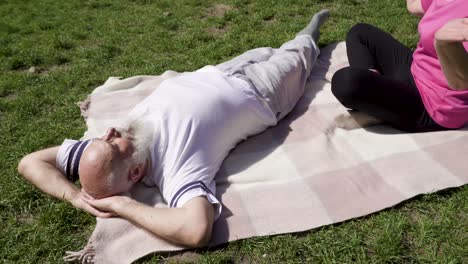 senior couple enjoy sun rays at green meadow