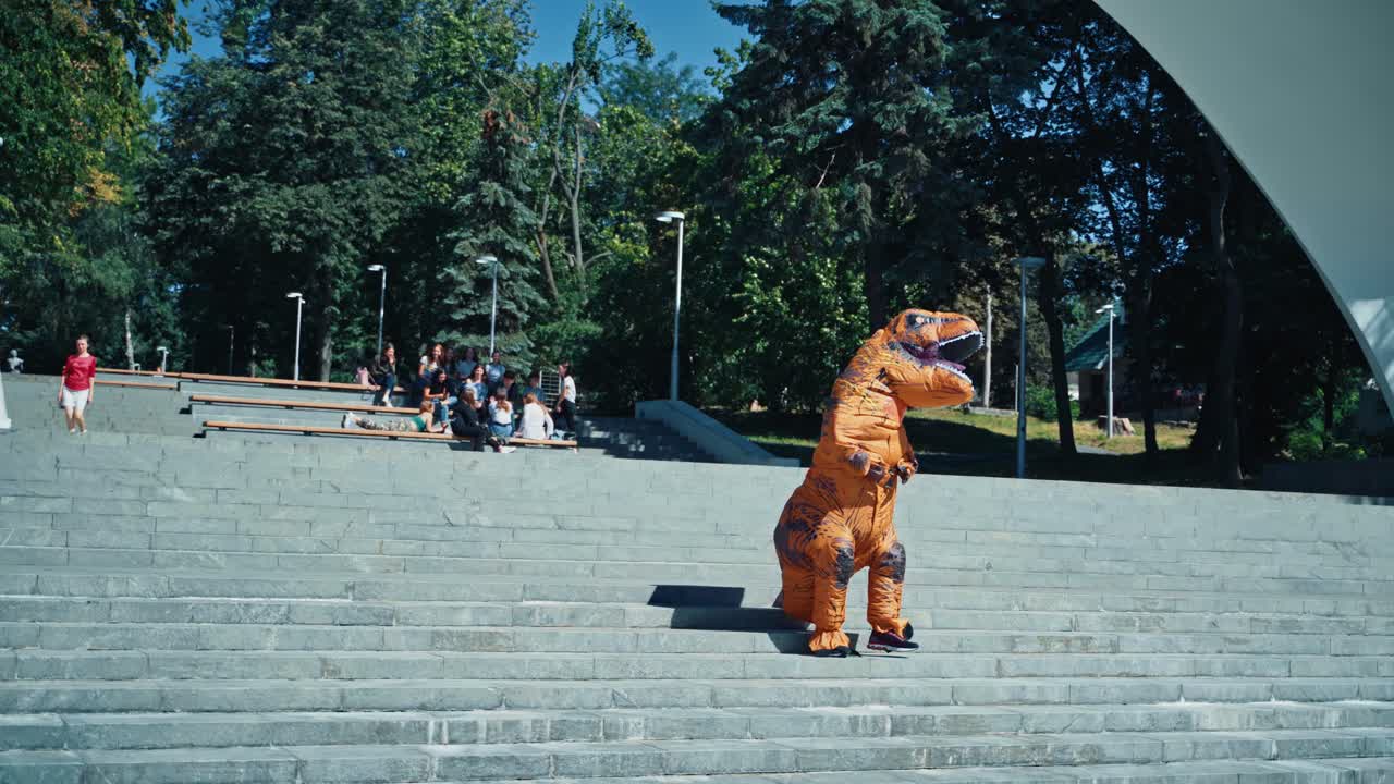 Dinosaur costume in city. Dinosaur t-rex walking in city