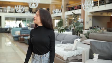 a woman is shopping for stylish furniture in a clearly modern and welldesigned store a fashionable woman explores a contemporary furniture store with a variety of chic sofas elegantly displayed