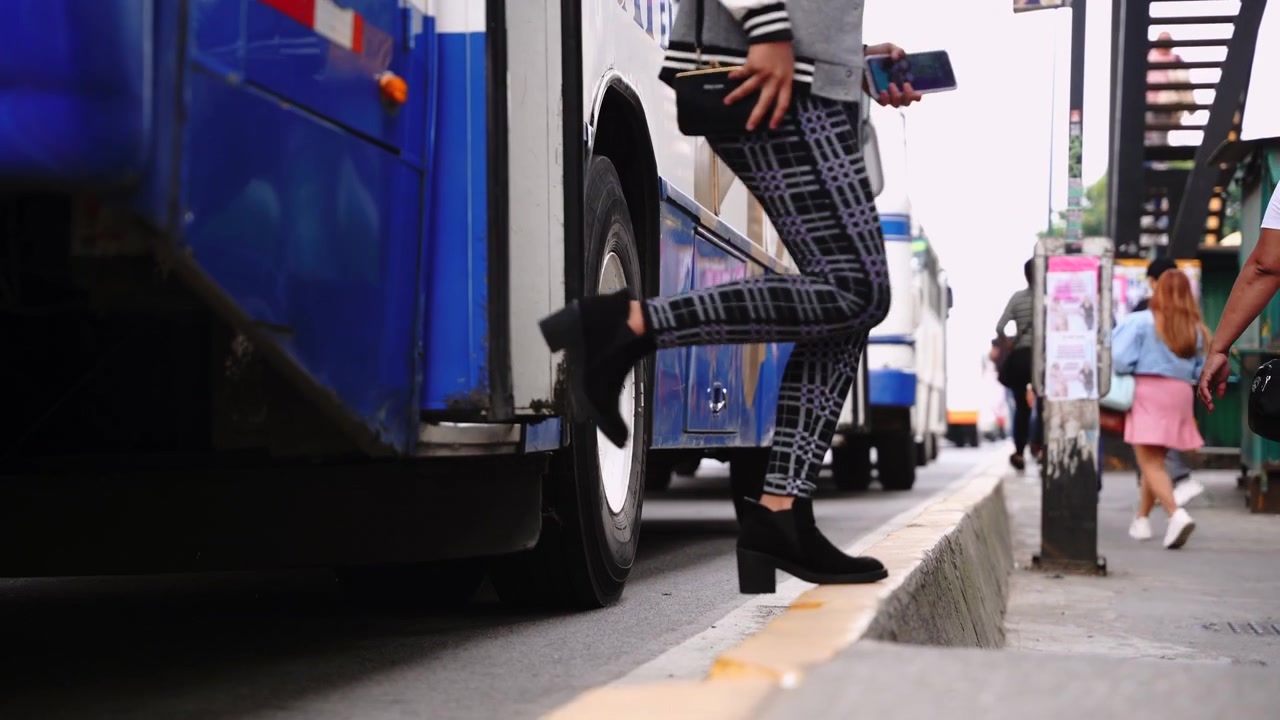Low angle steps of people getting of bus Xalapa Mexico