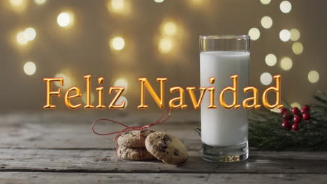 feliz navidad text in orange over christmas cookies and milk and bokeh lights background