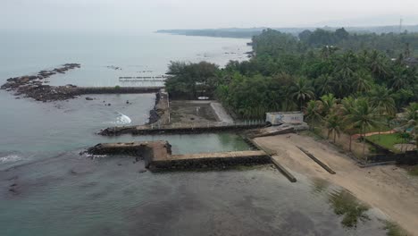 coastal landscape with pier and tropical vegetation