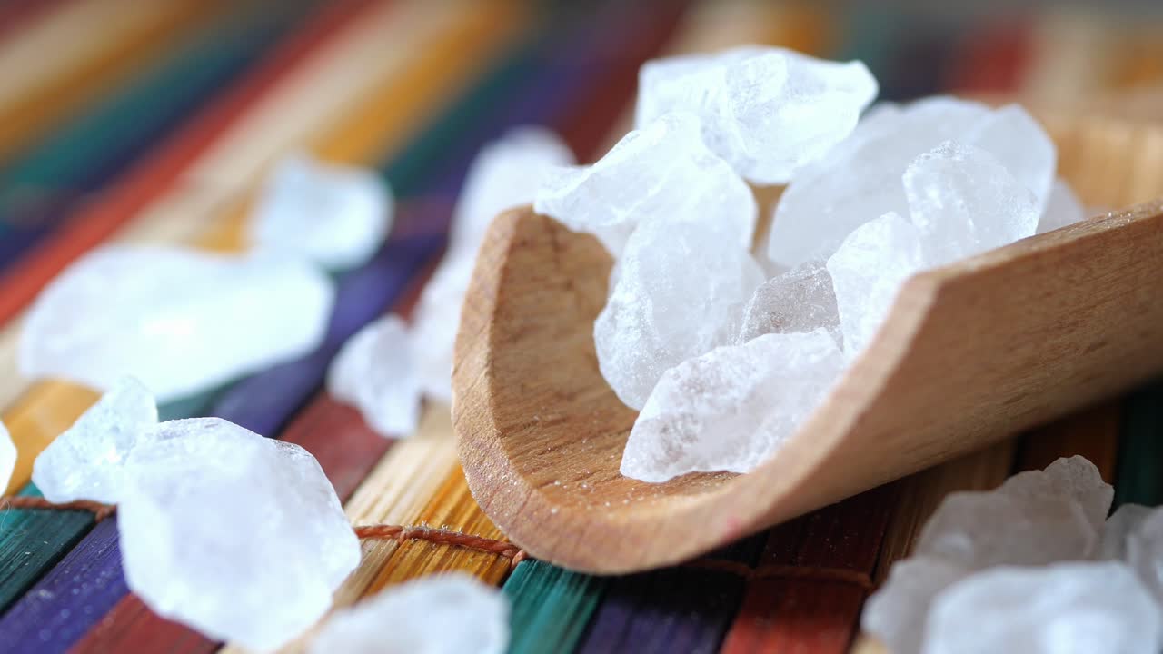 Close-up of rock salt crystals in a wooden spoon