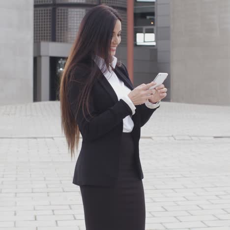 attractive businesswoman checking her mobile phone