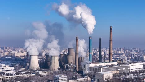 rotating drone view of a energy power plant releasing white smoke in the atmosphere with a city in the background, bucharest, romania