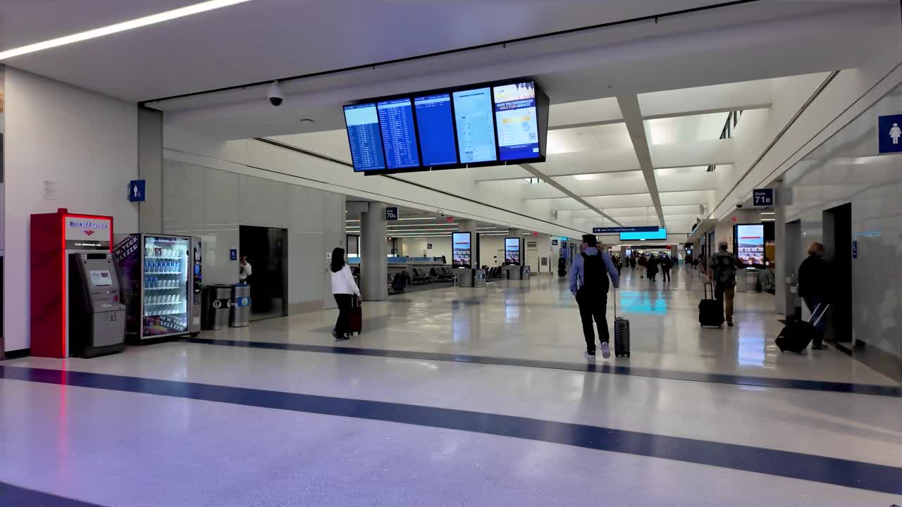 Modern Airport Terminal Hallway with Travelers and Gate Signs