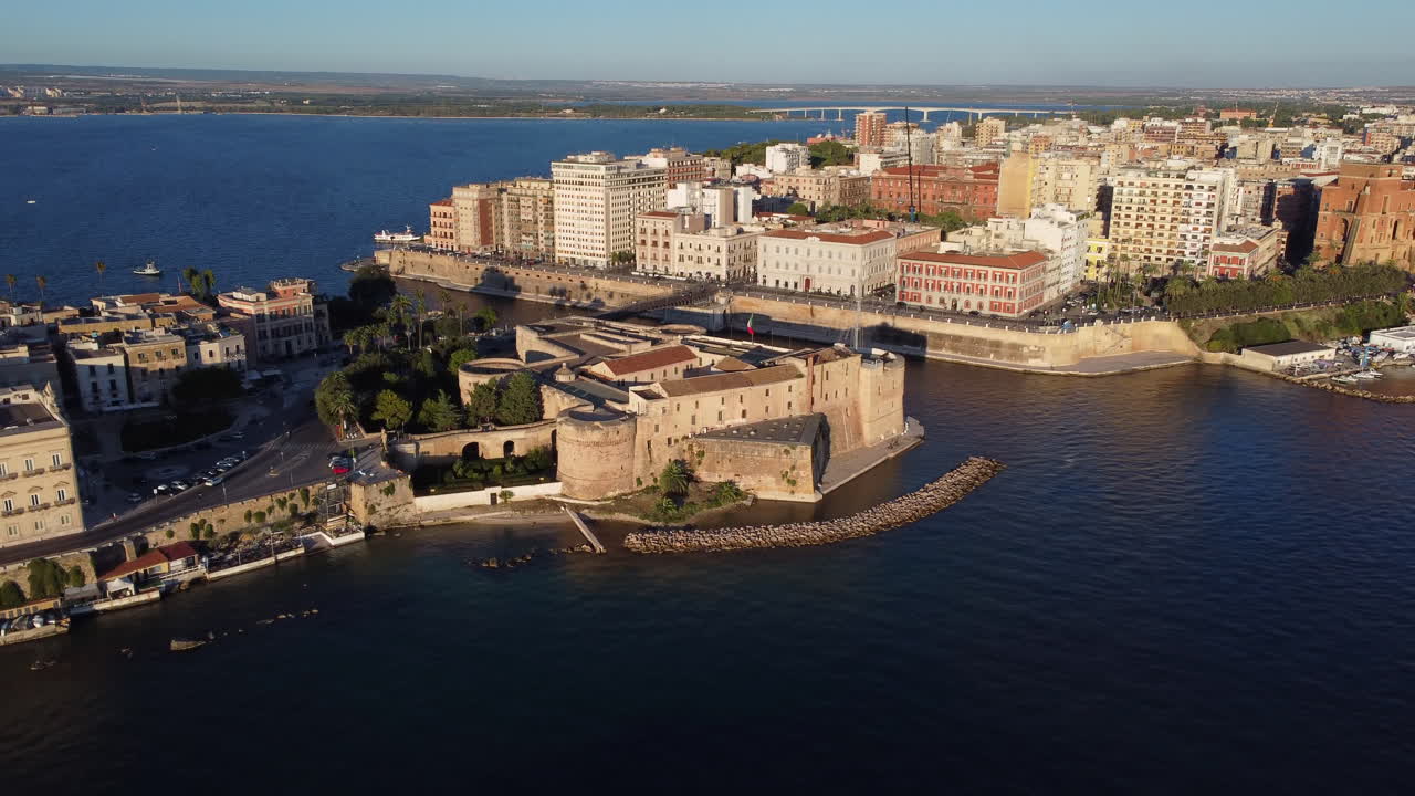 Aerial flying backwards from Castello Aragonese in Taranto, Italy