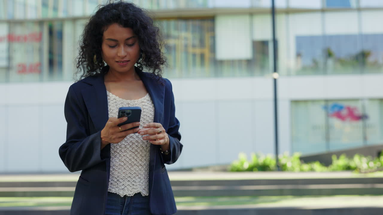 Woman using smartphone outdoors in a city
