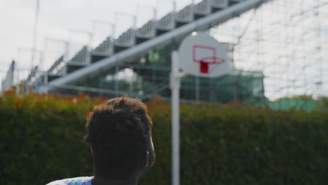 man playing basketball outdoors