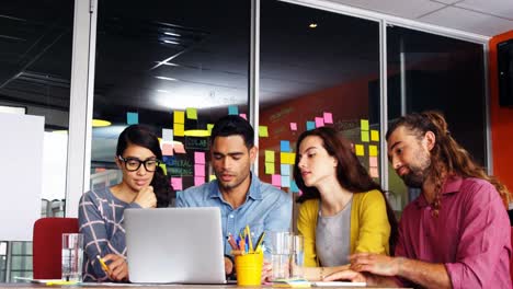 Executives-having-discussion-over-laptop