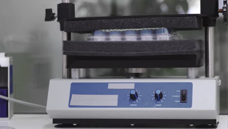 machine for shaking test tubes by vibration to separate the cells and to continue studies