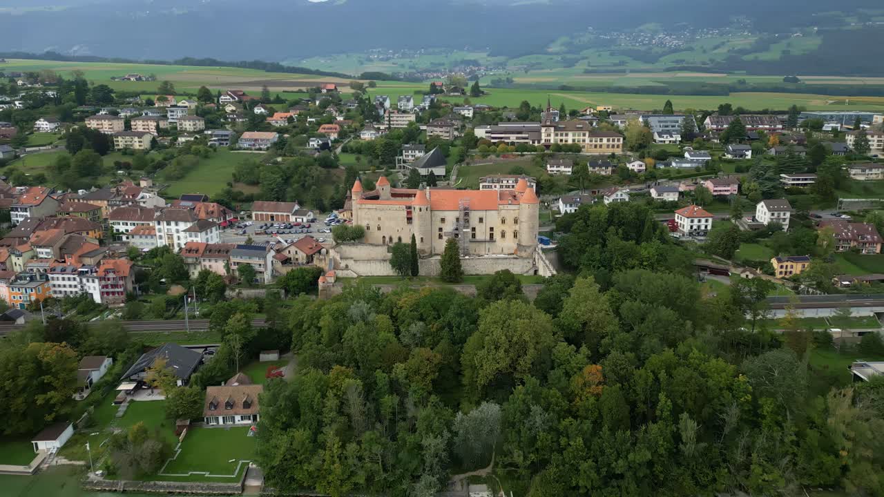 Crane drone shot of Grandson Castle next to Lake Neuchatel in Canton of Vaud in Switzerland.