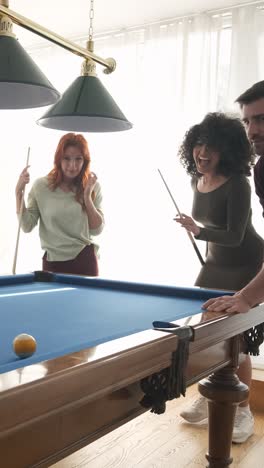 black woman successfully hitting pool ball