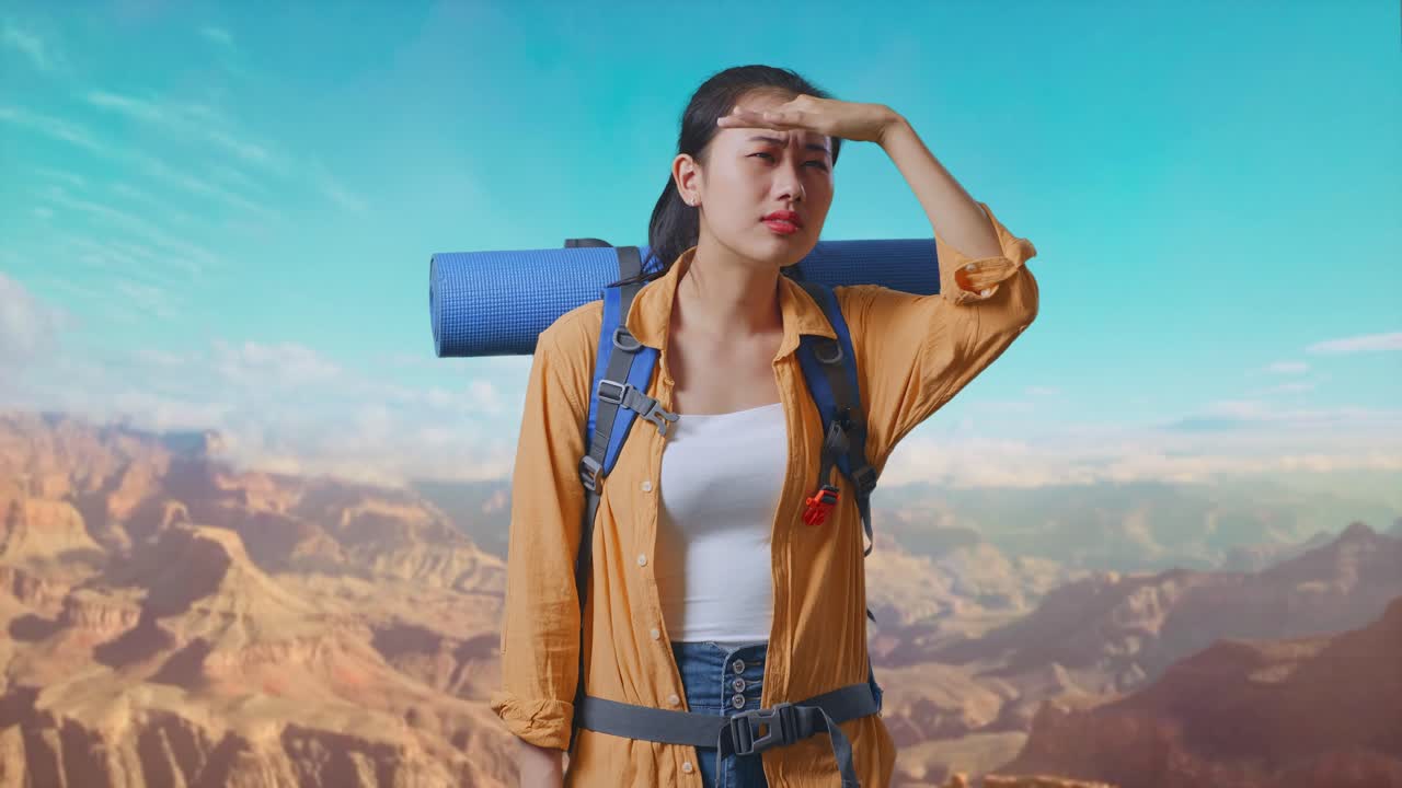 Asian Female Hiker With Mountaineering Backpack Hand Forehead Smiling And Looking Distance While Traveling At The Top Of Mountain